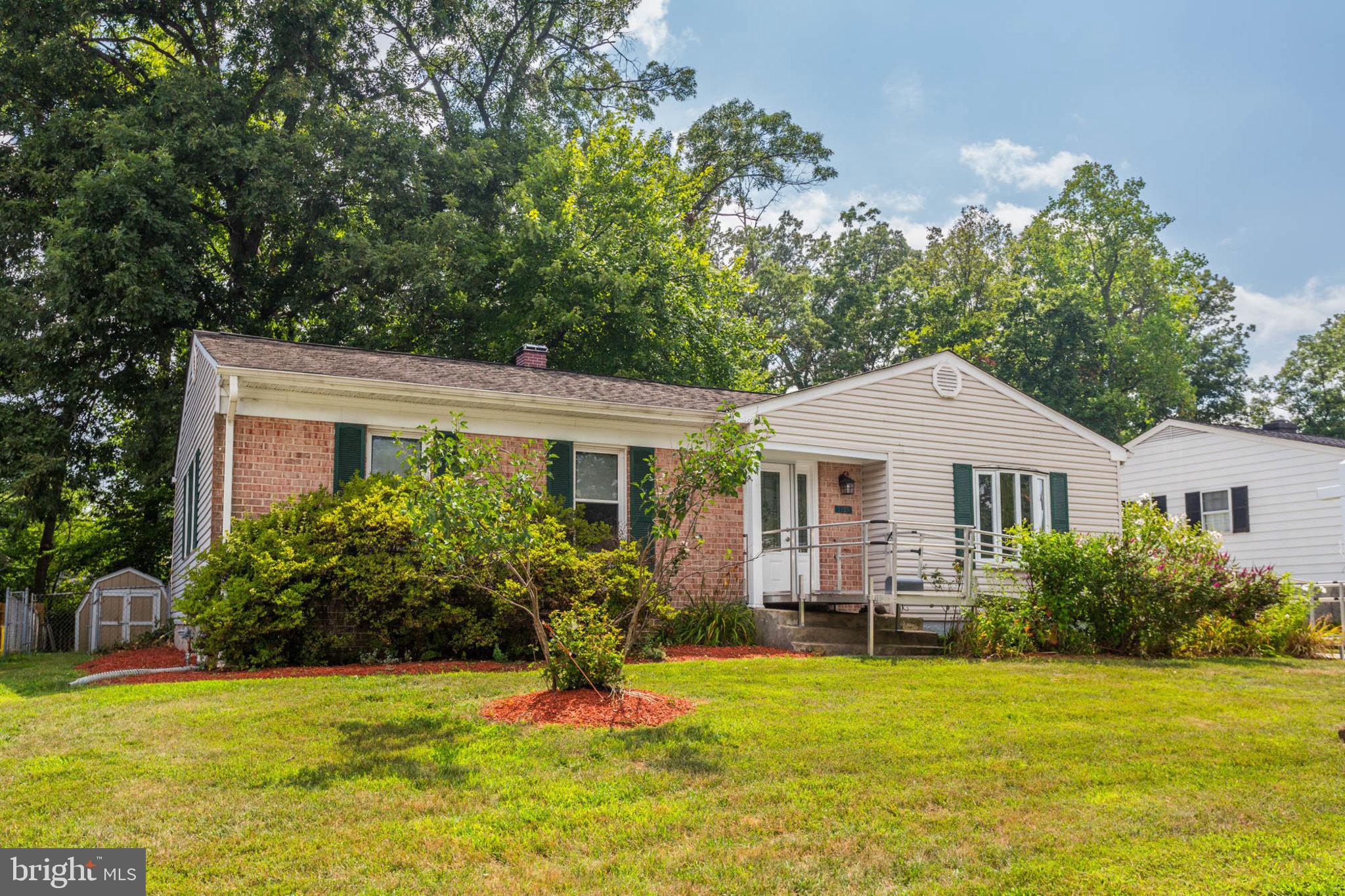 a view of a house with a yard and potted plants