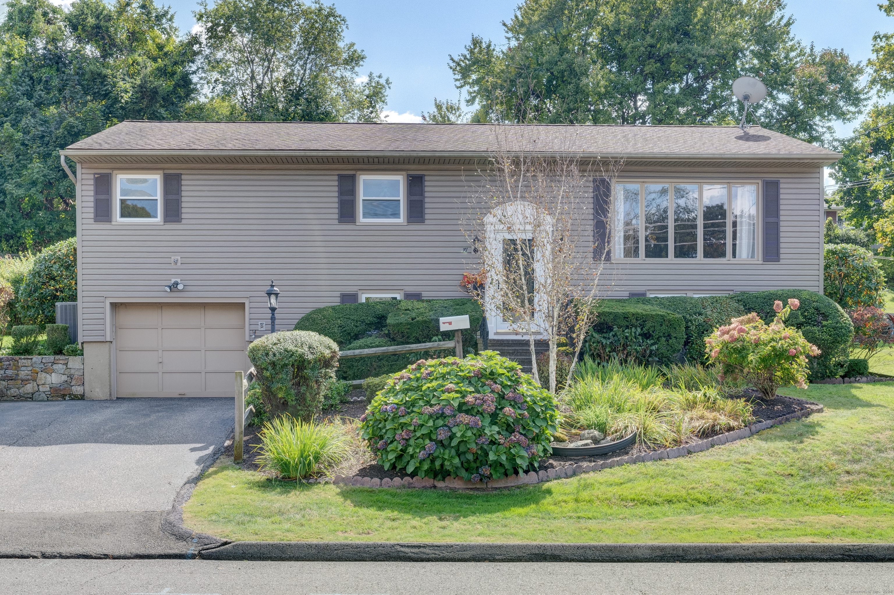 a front view of a house with garden