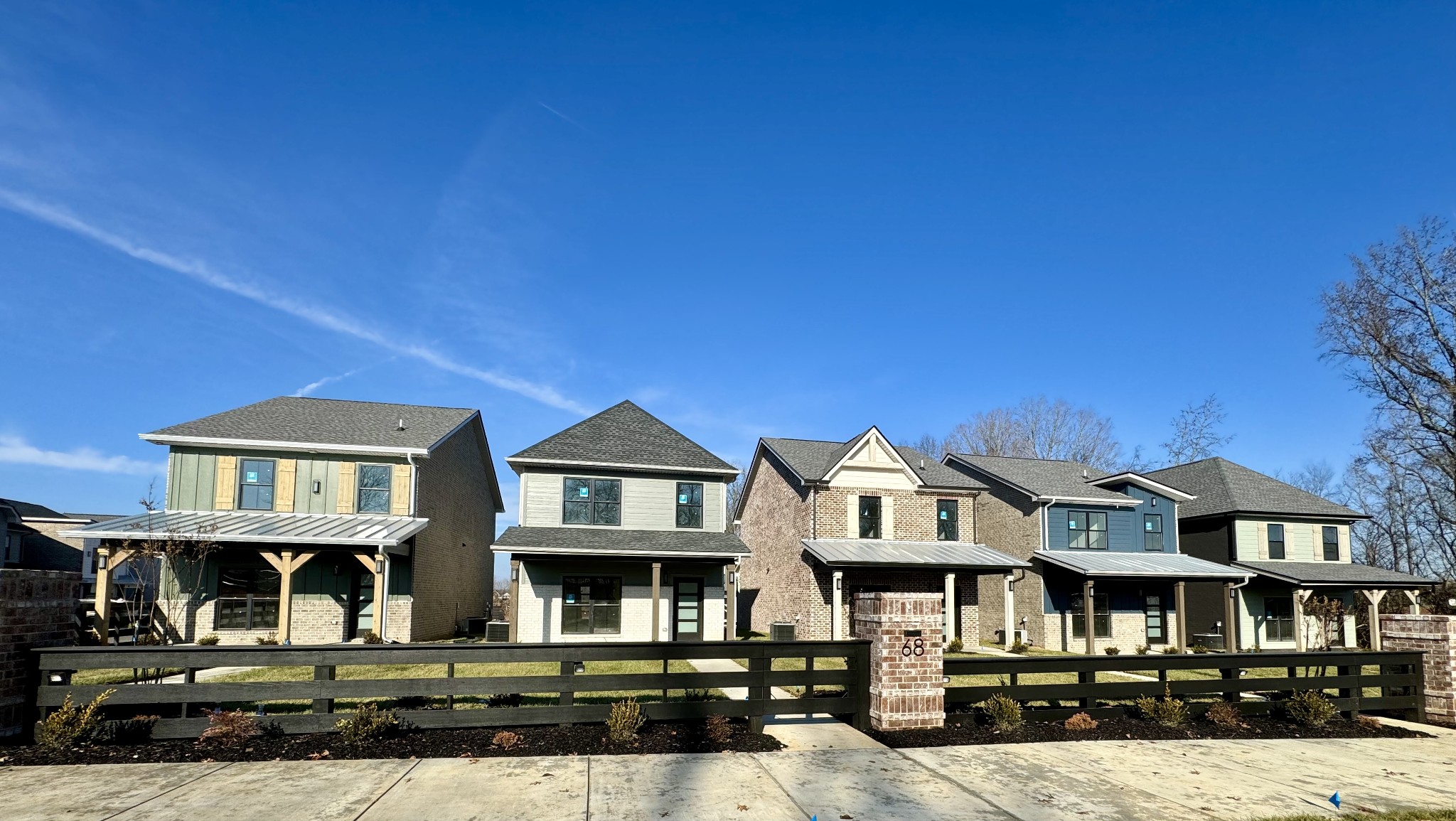 a front view of a residential apartment building with a yard