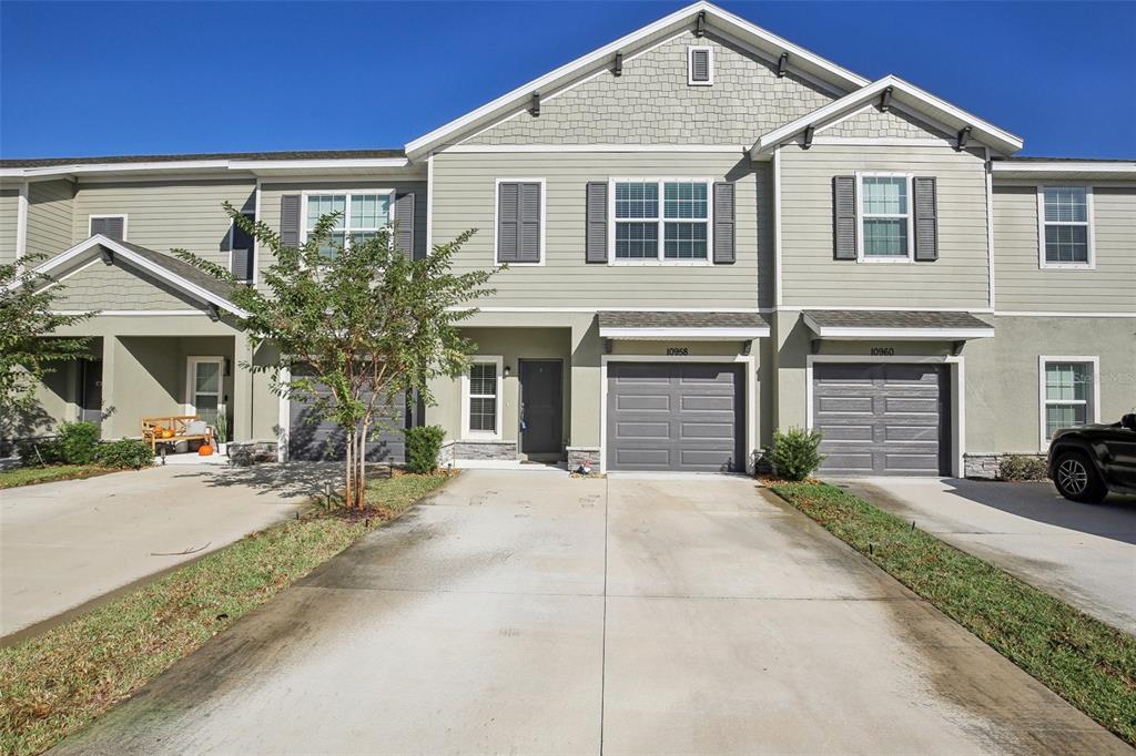 a front view of a house with a yard and garage