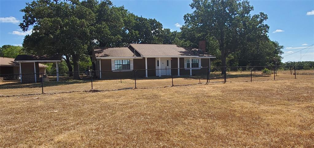 a view of a house with a backyard