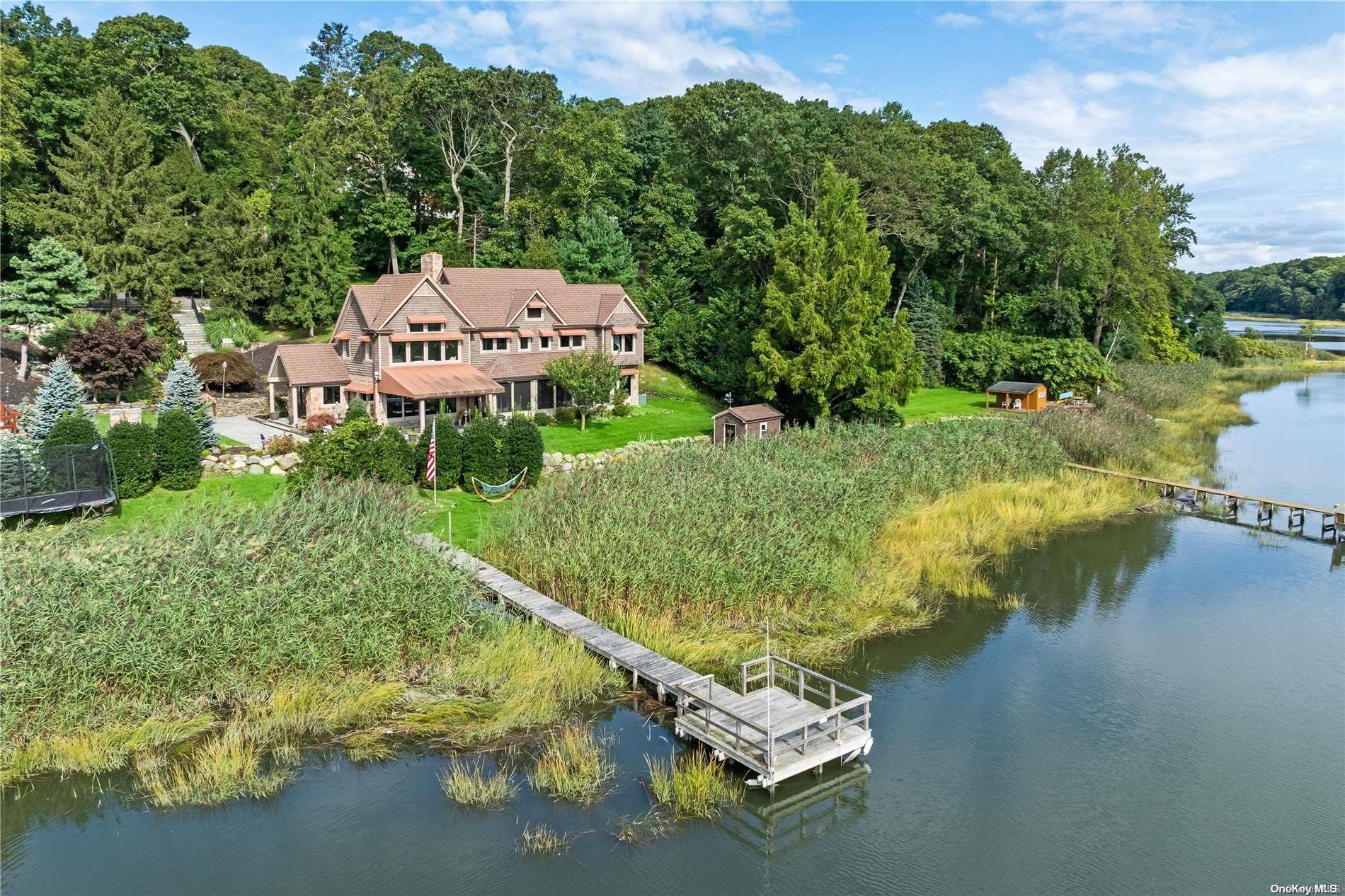 an aerial view of a house with a yard basket ball court and outdoor seating