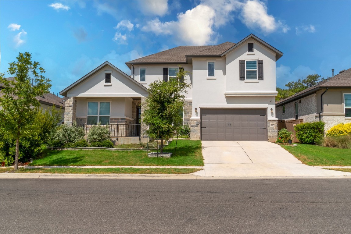 a front view of a house with a yard and garage