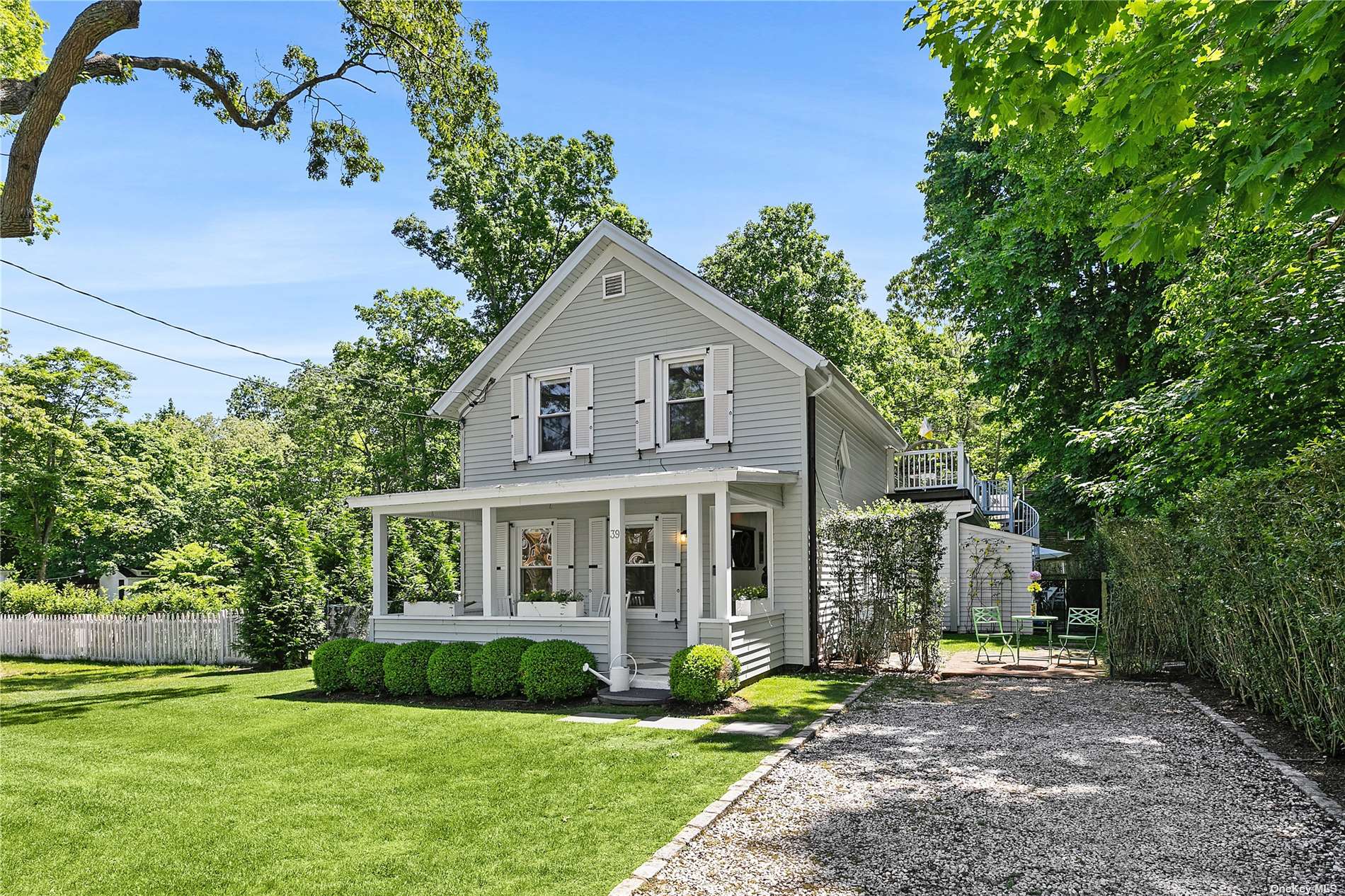 a front view of a house with a garden and yard