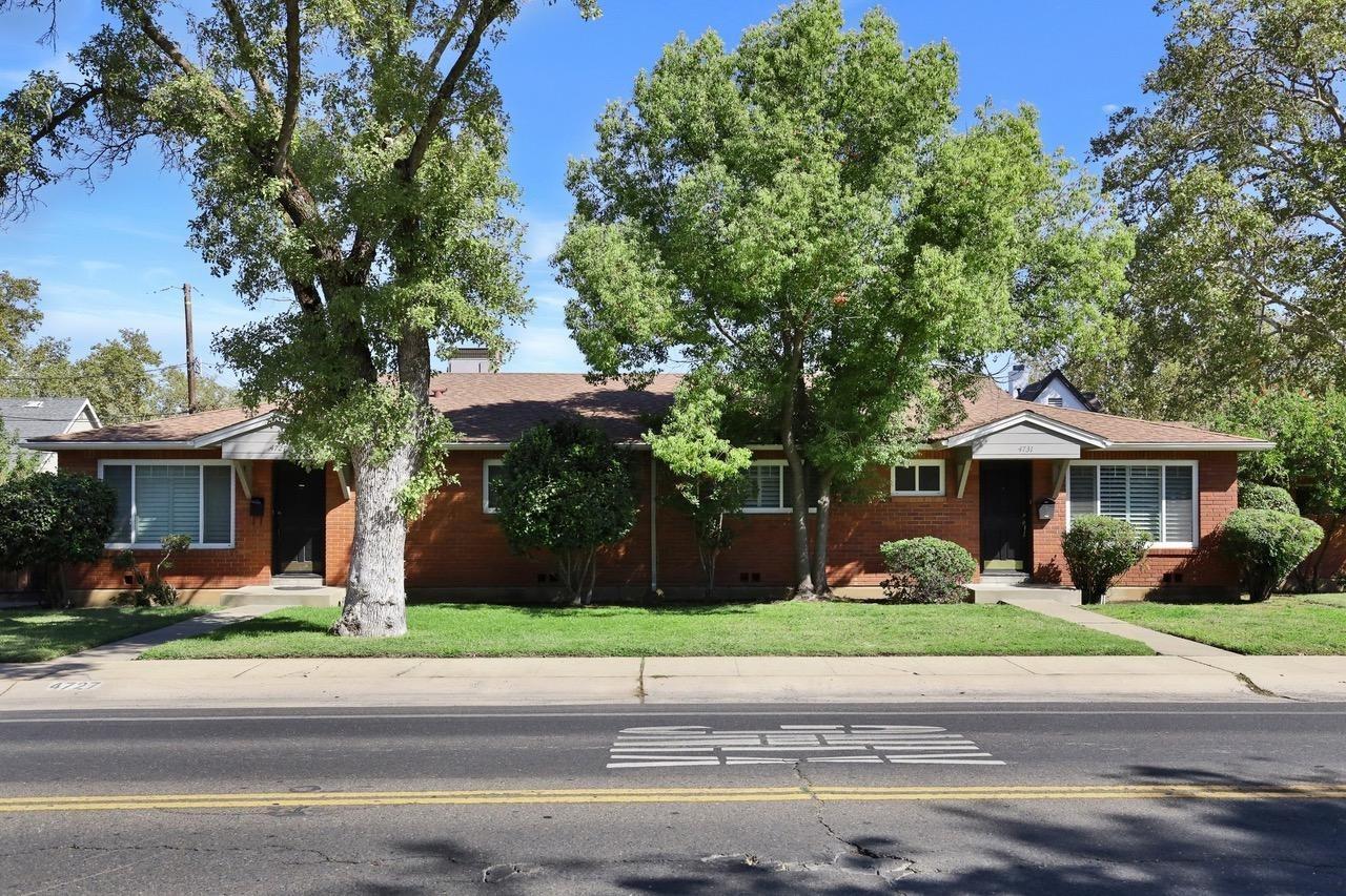 a front view of a house with a garden