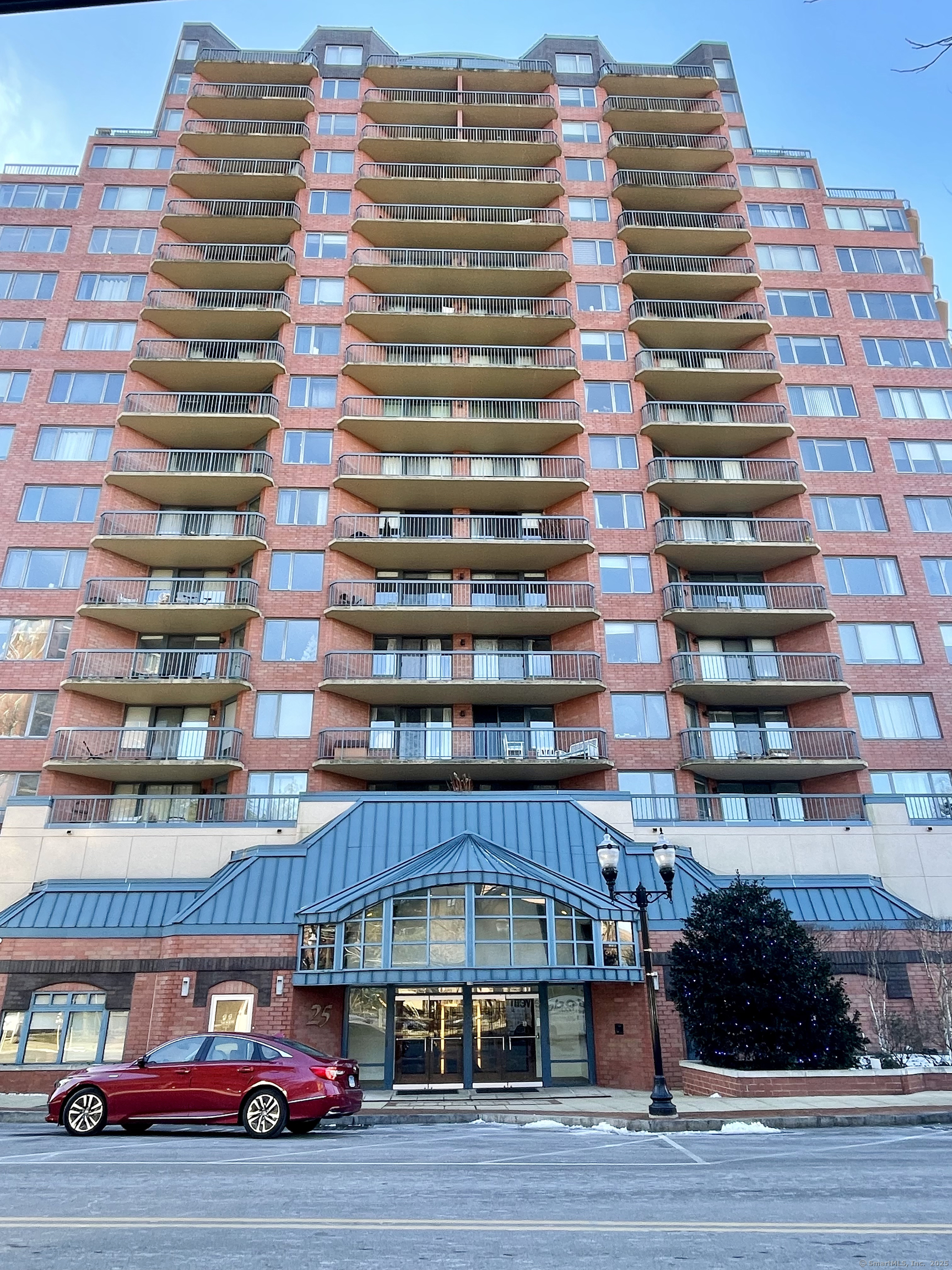 a front view of a building with glass windows and garage