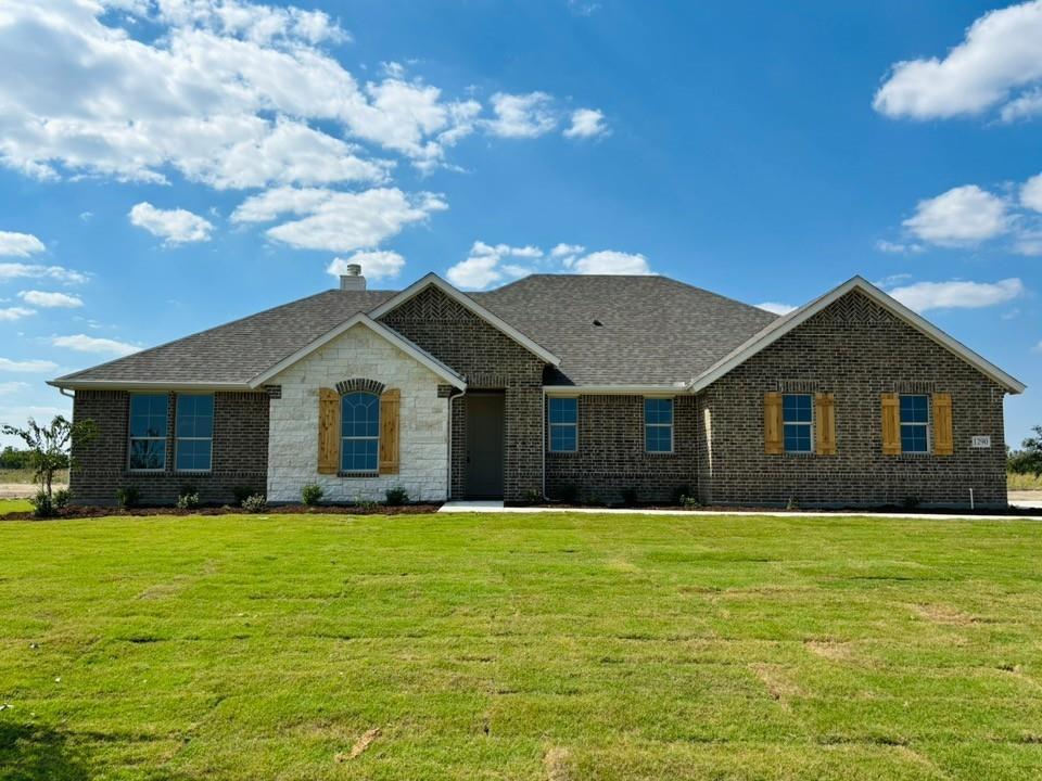 a front view of house with yard and green space