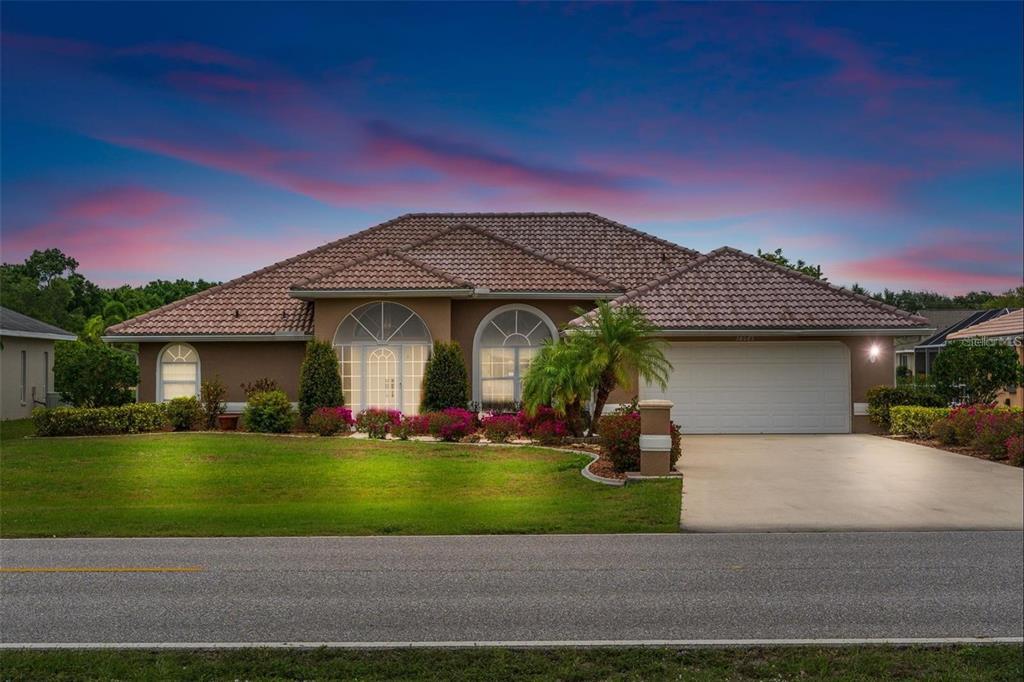 a front view of a house with a yard and garage