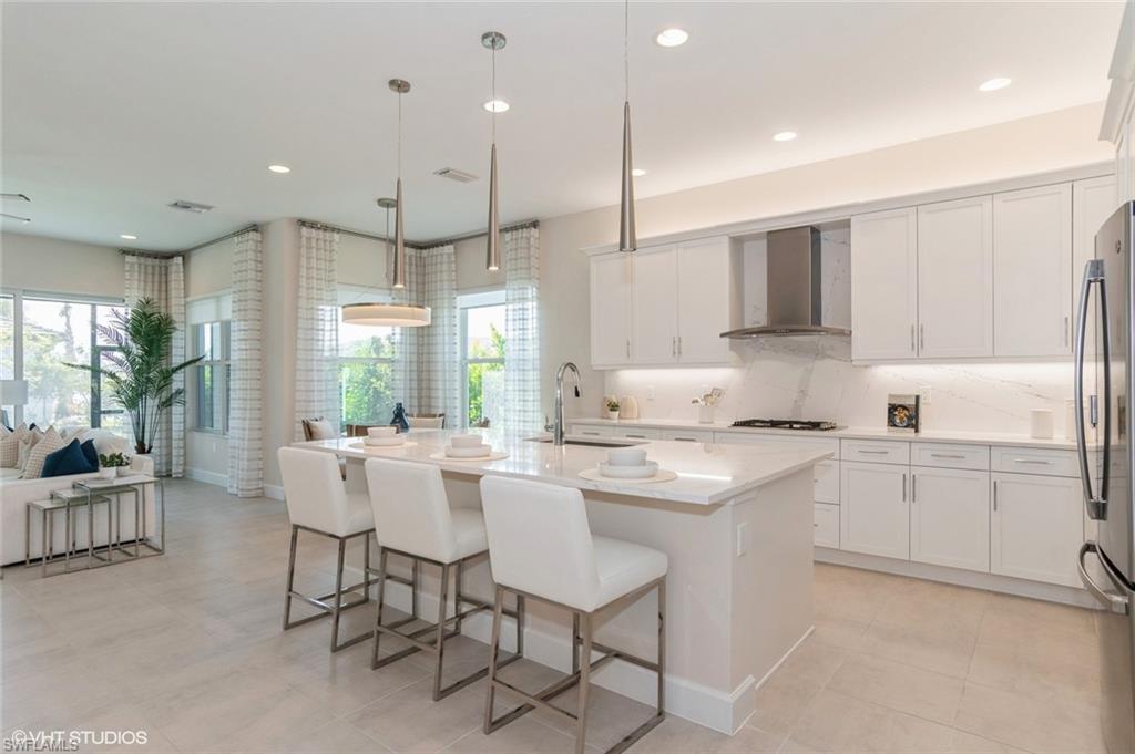 Kitchen with pendant lighting, sink, lots of storage, and a kitchen island