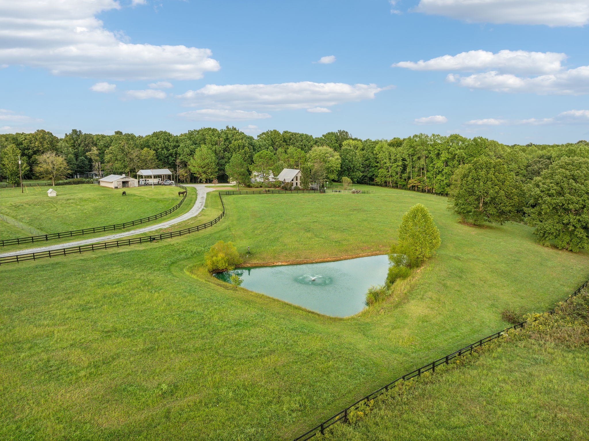 an aerial view of a houses with outdoor space swimming pool and green space