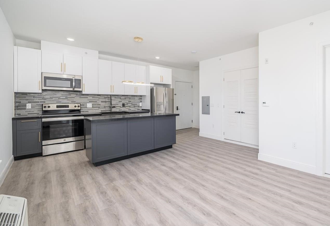 a kitchen with stainless steel appliances granite countertop a stove top oven sink and cabinets