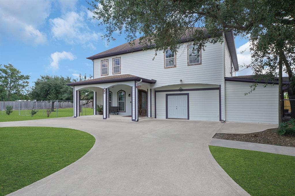 a front view of a house with a garden and yard