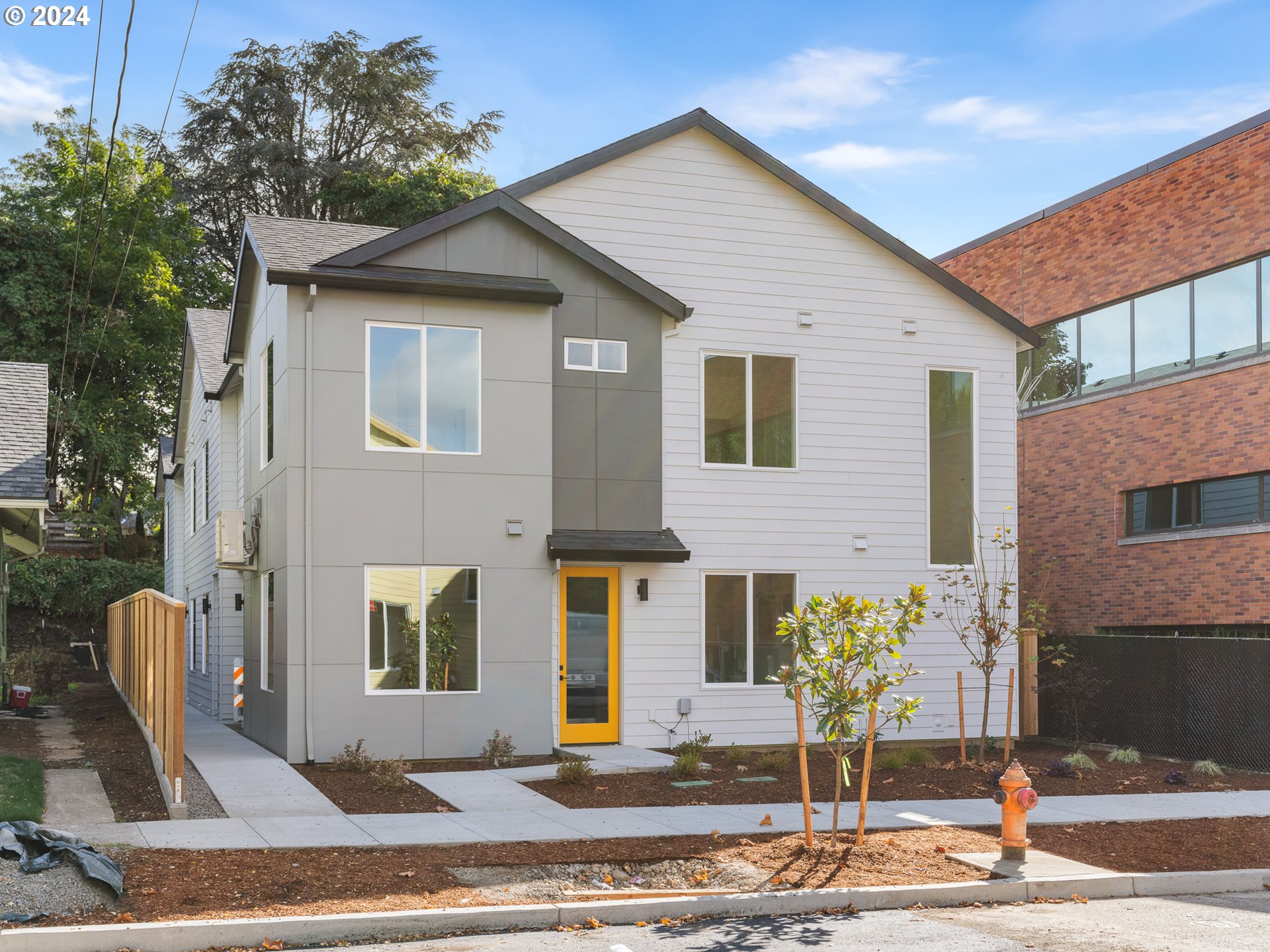 a front view of a house with a yard garage and outdoor seating