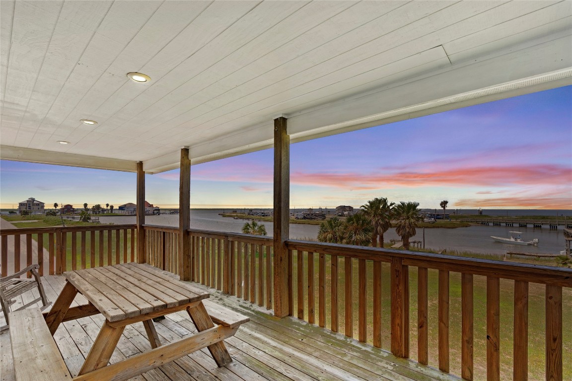 a view of a balcony with wooden floor and outdoor space