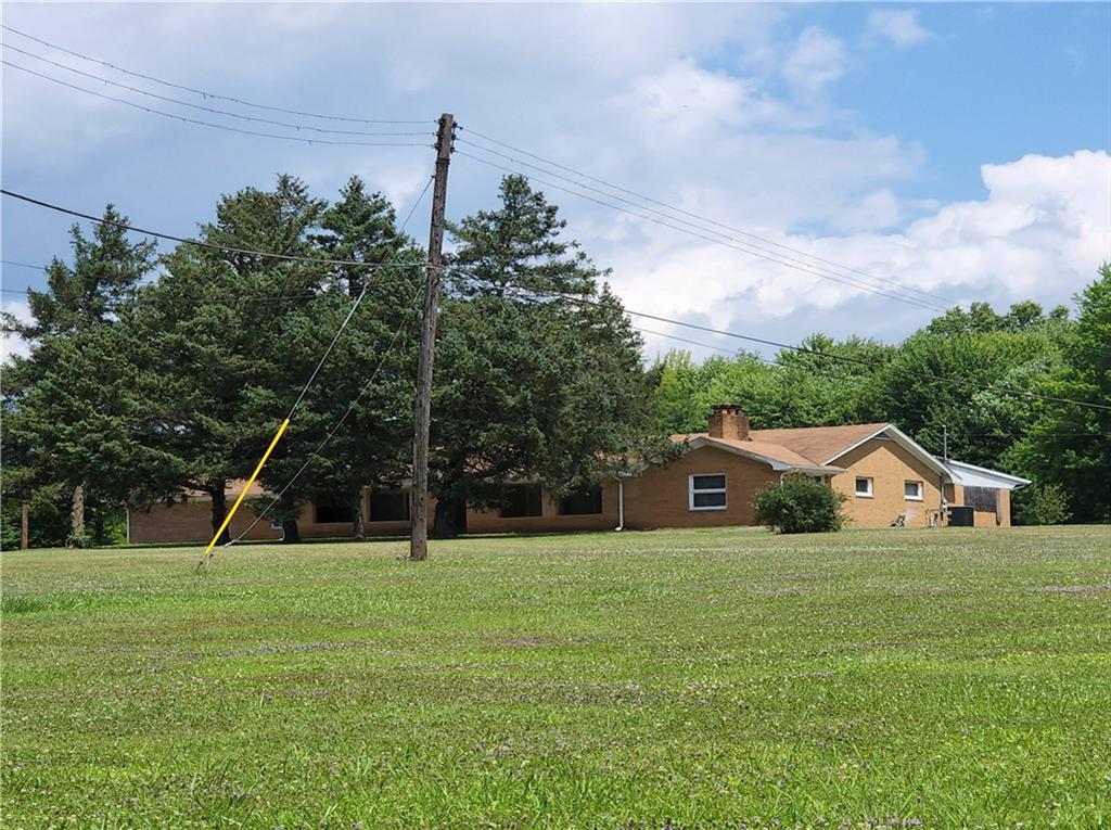 a house with huge green field in front of it