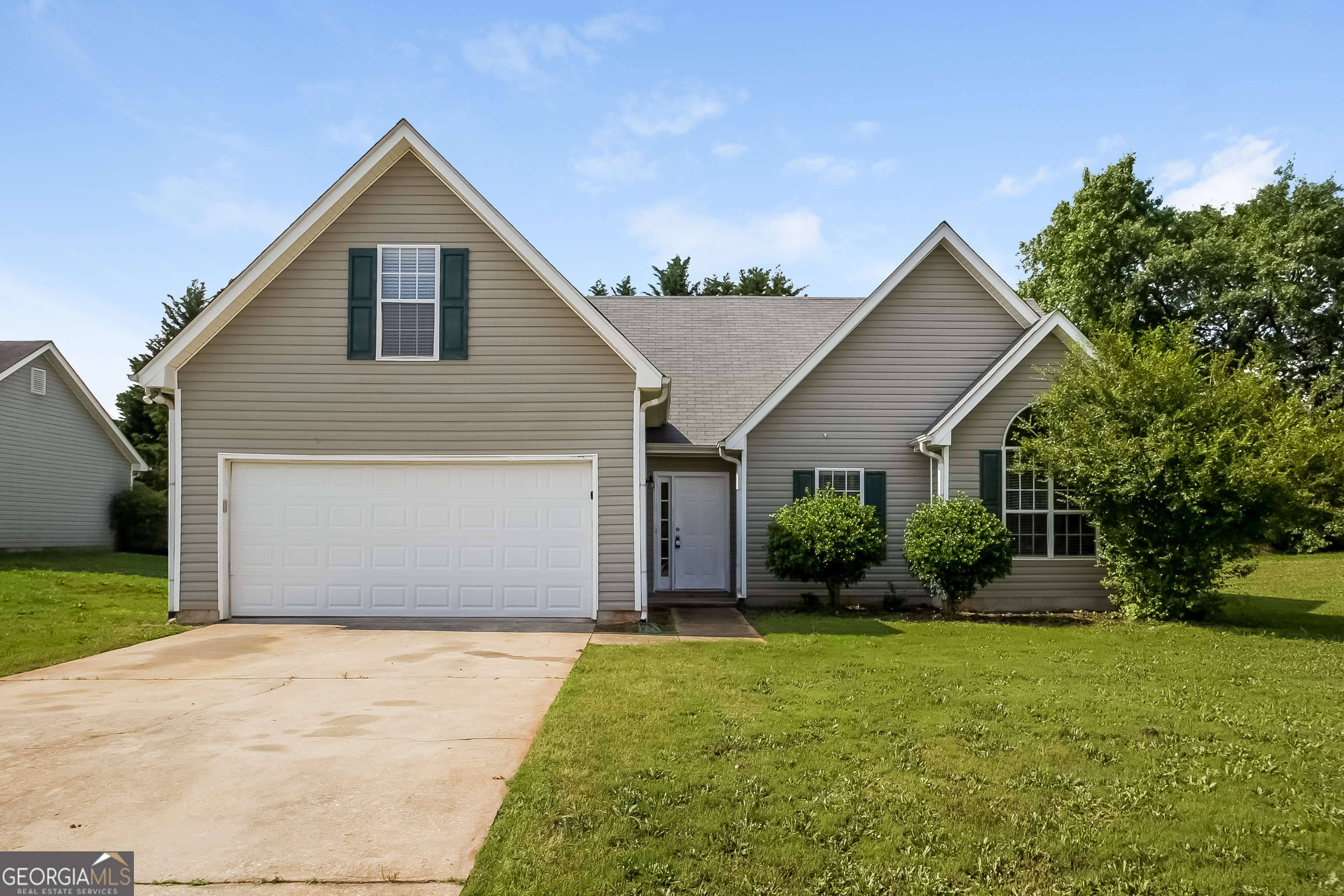 a front view of house with yard and green space