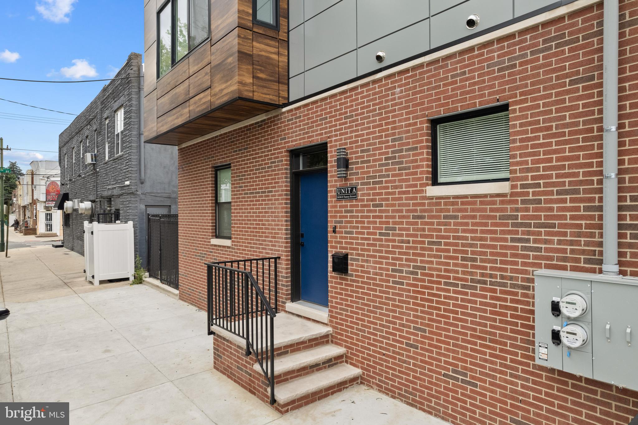 a view of a brick house with many windows