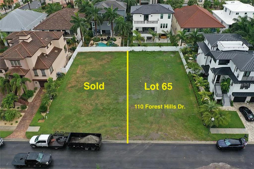 an aerial view of a house with garden space and street view