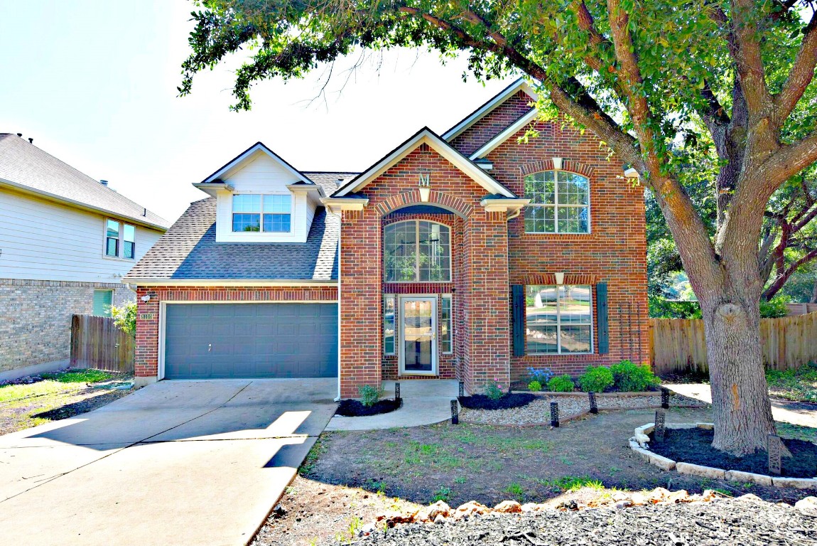 a front view of a house with a yard and garage