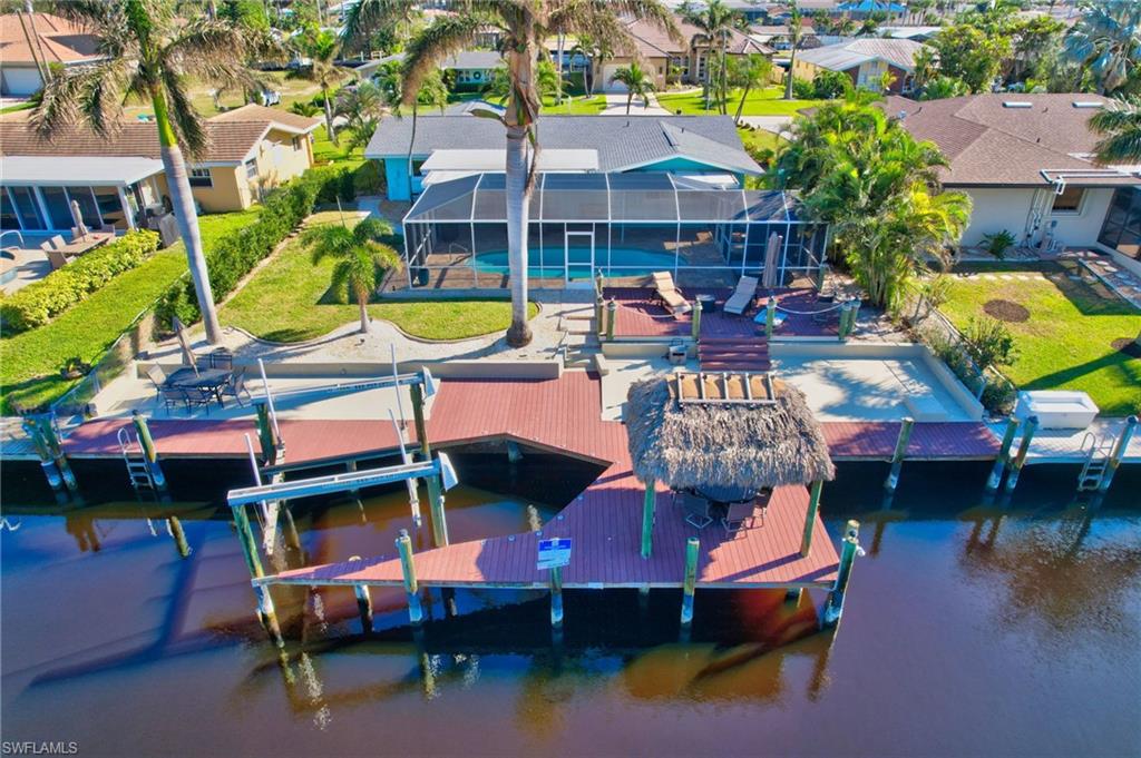 an aerial view of a house with swimming pool and a patio