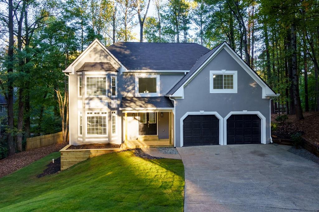 a front view of a house with a yard and garage