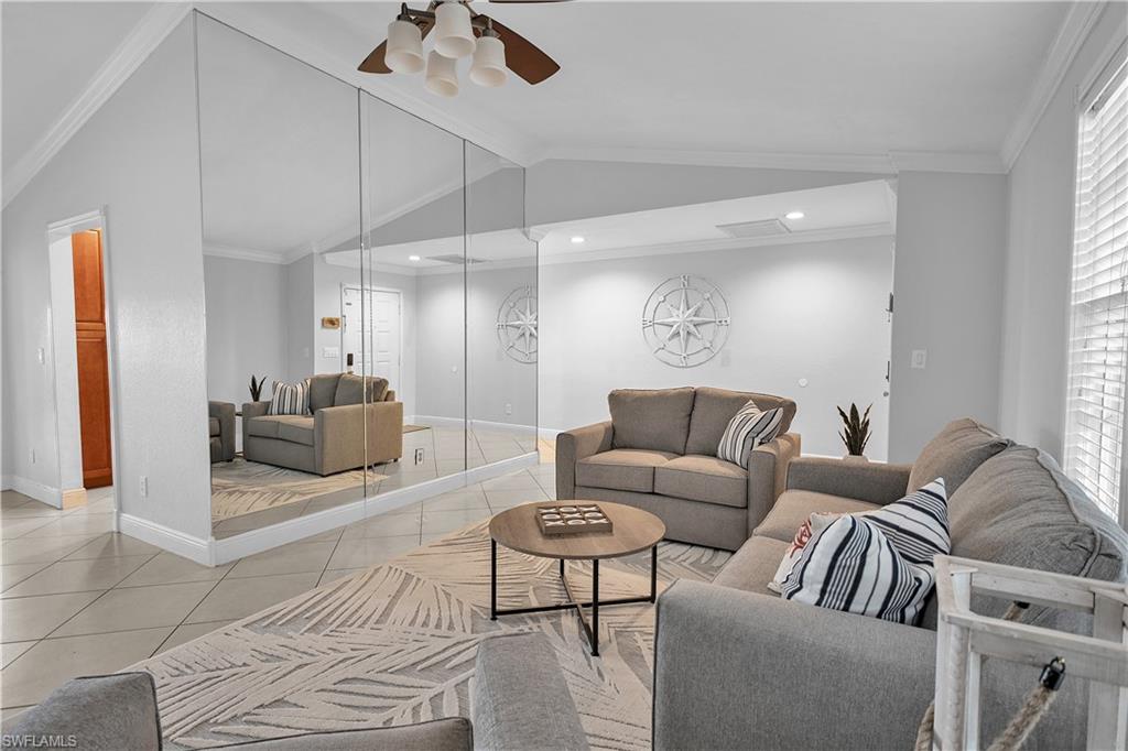 a living room with furniture and a glass door