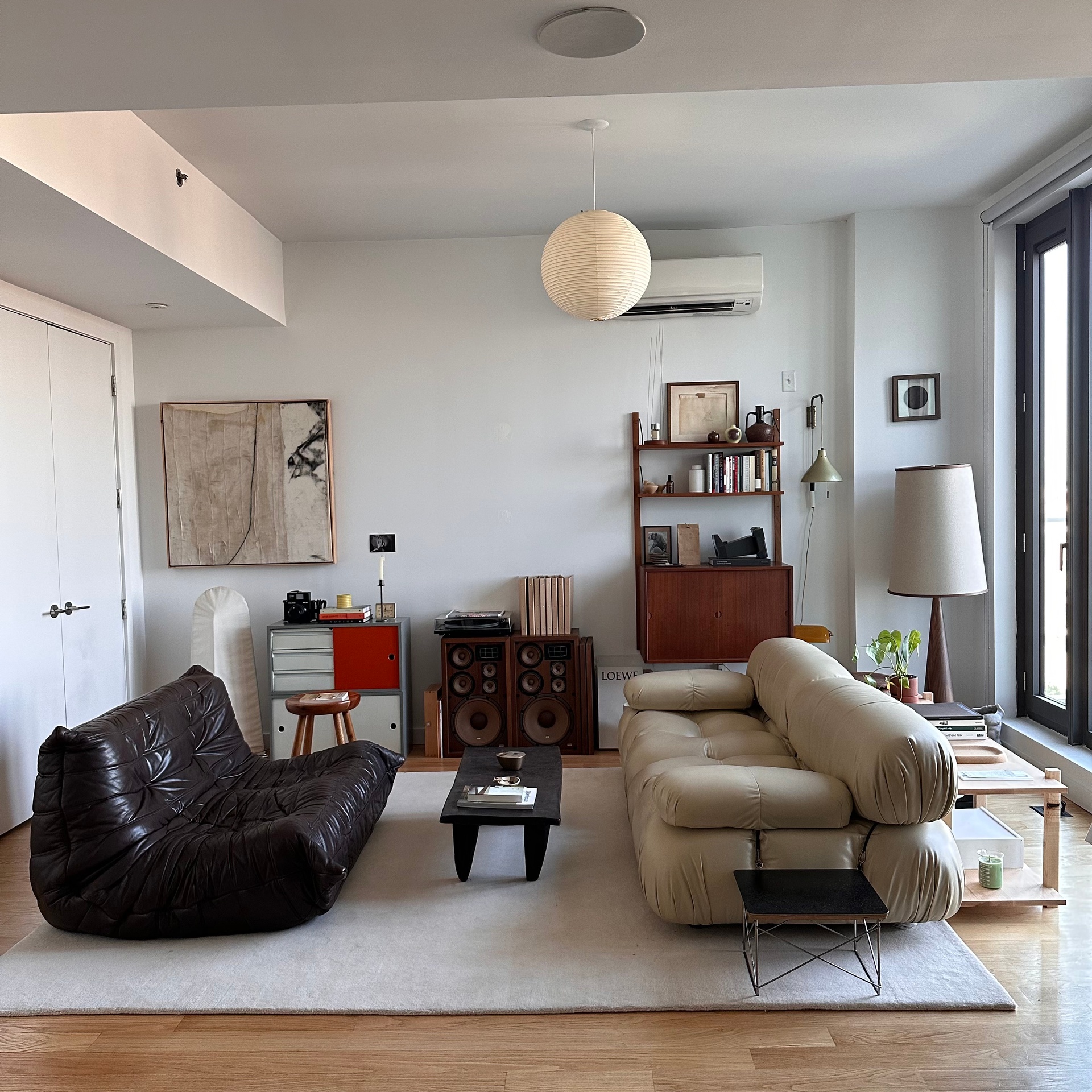 a living room with furniture and a lamp