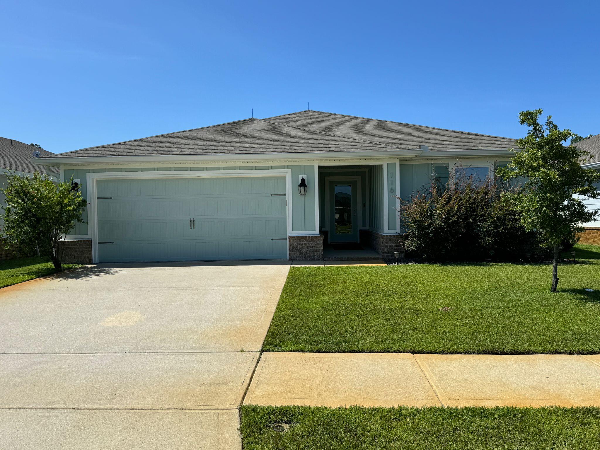 a front view of a house with a garden