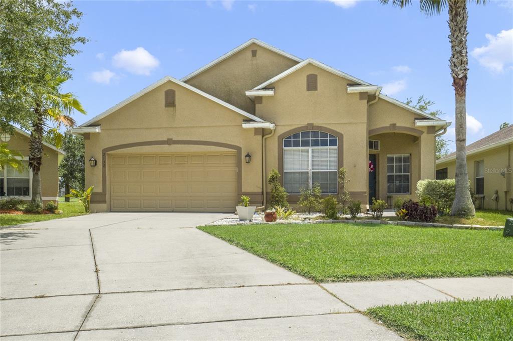 a front view of a house with a yard and garage