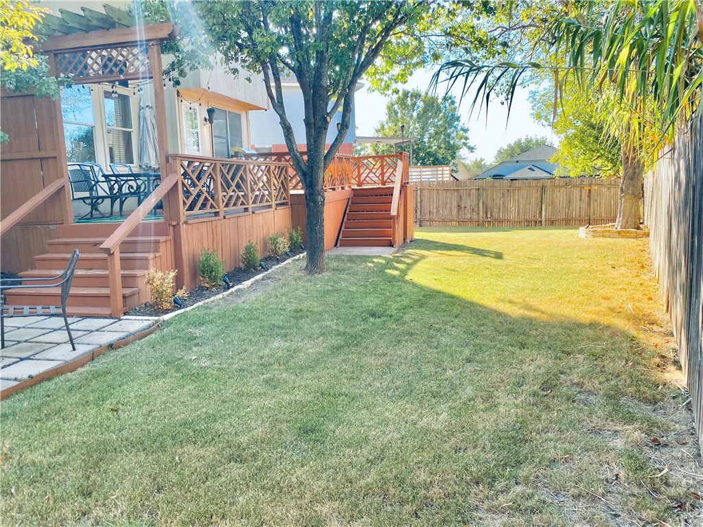 a view of a backyard with a tree