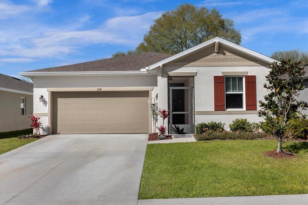 a front view of a house with a yard and garage