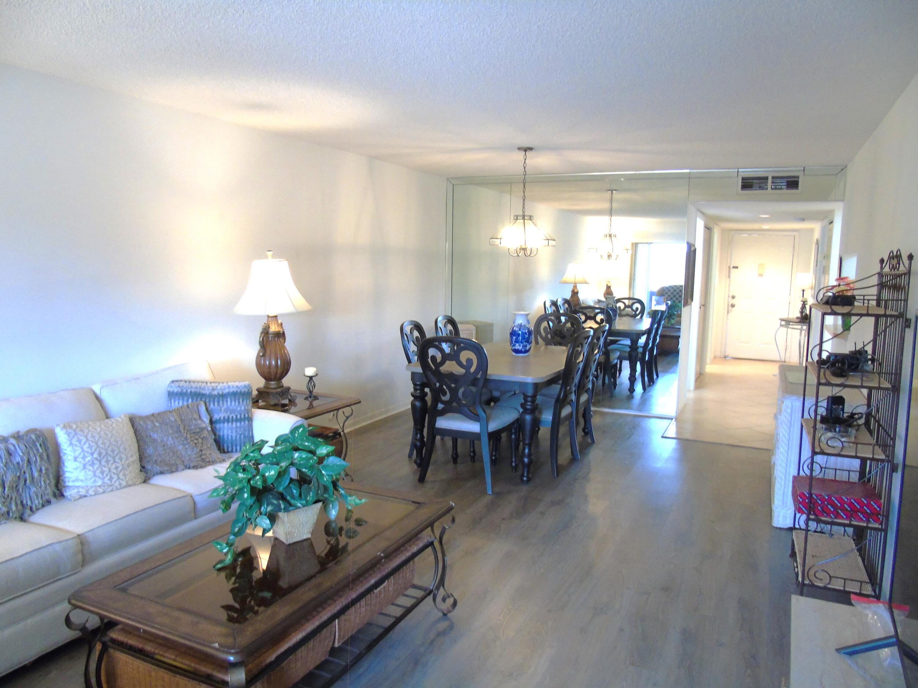 a living room with furniture potted plant and a table