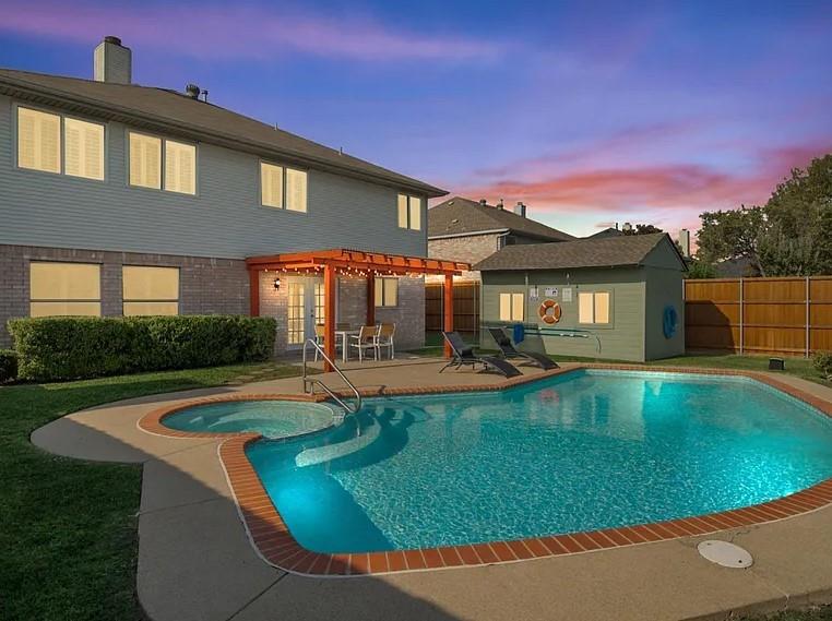 a view of a house with swimming pool and a yard