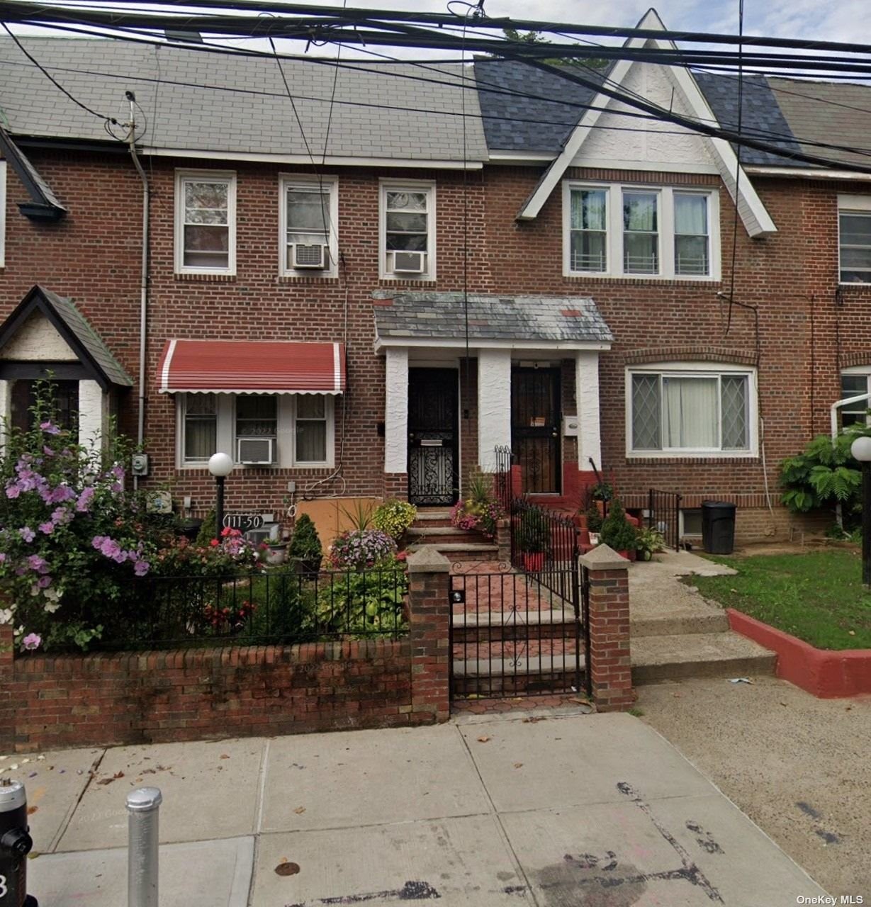 a view of a house with brick walls and a yard