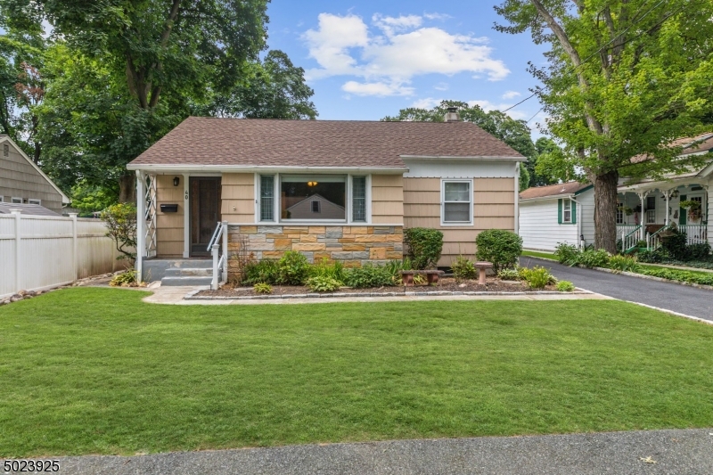 a front view of house with yard and green space