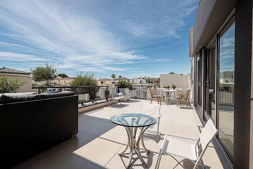 a view of a balcony with chairs and a table