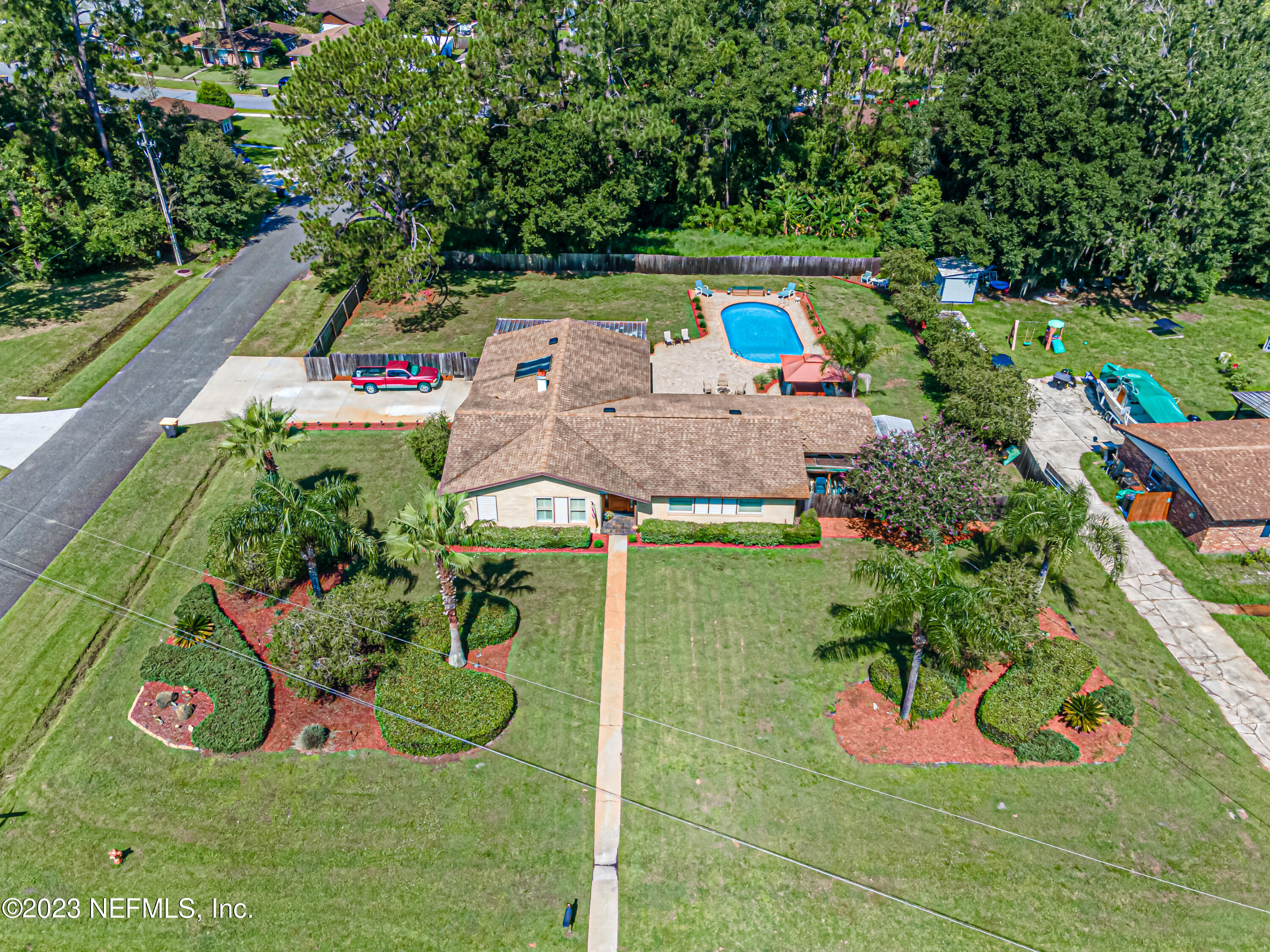 an aerial view of a house with yard swimming pool and outdoor seating