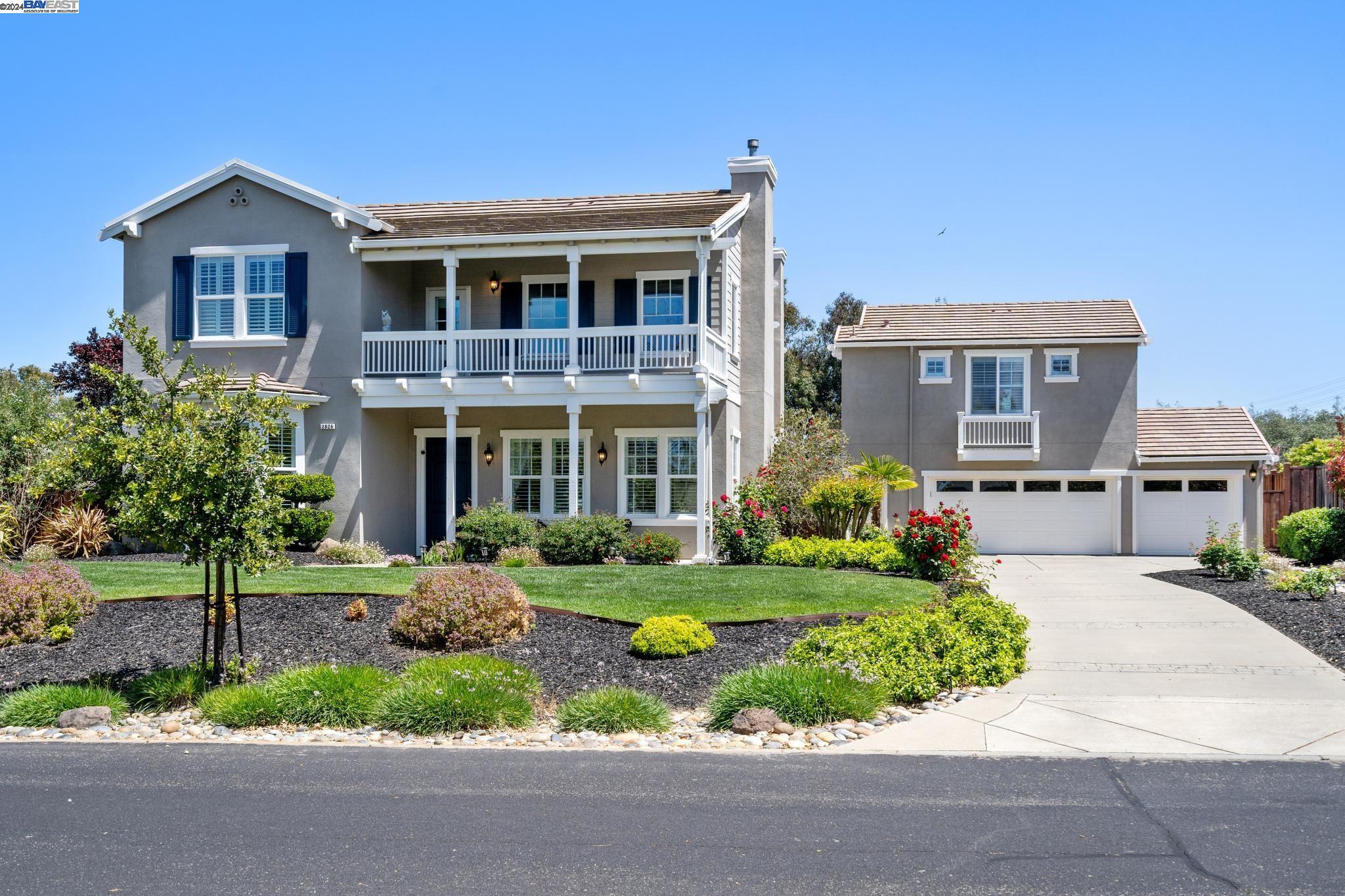 a front view of a house with a yard and porch