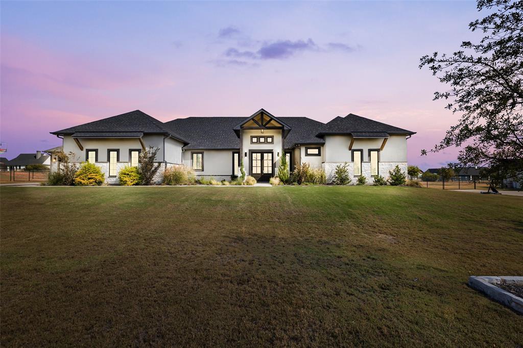 a front view of a house with a garden