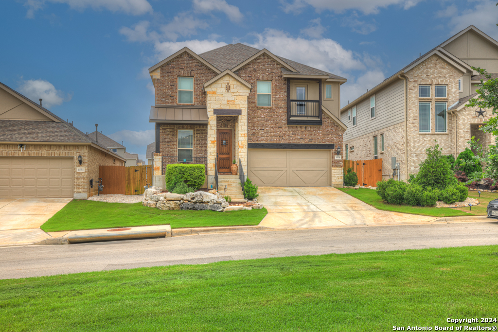 a front view of a house with a yard and garage