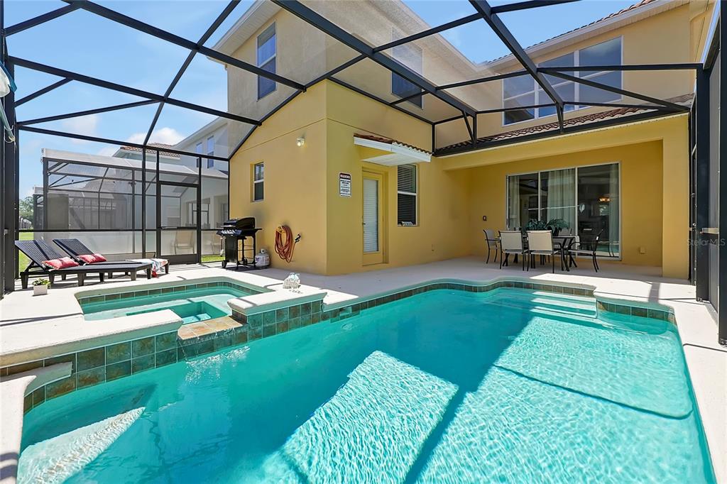 a backyard of a house with table and chairs