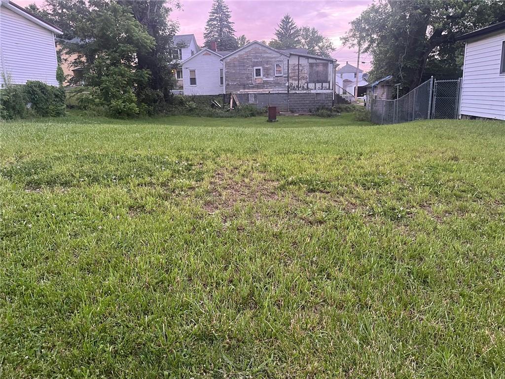 a view of a yard with a house in the background