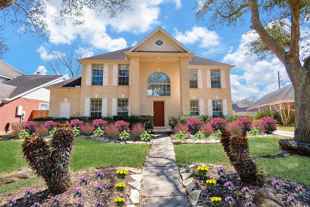 a front view of house with yard and outdoor seating