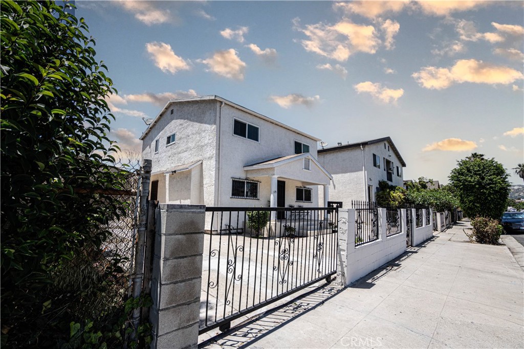 a view of a house with wooden fence