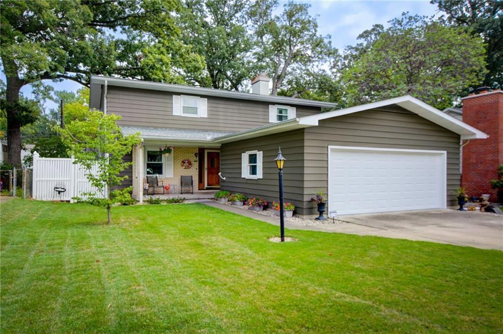 a view of a house with a yard and sitting area