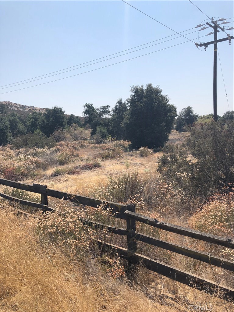 a view of a yard with wooden fence