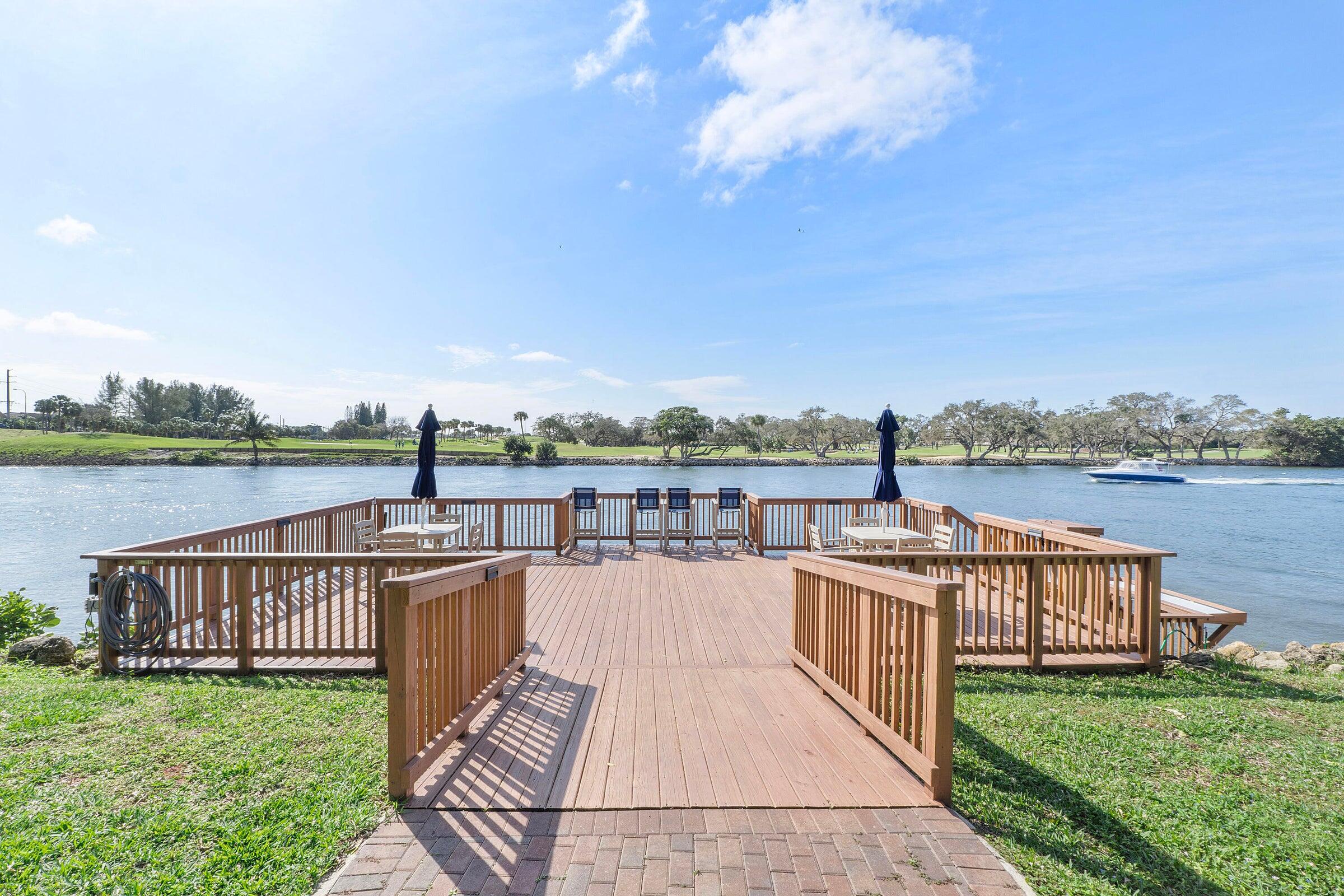 a balcony with wooden floor and lake view