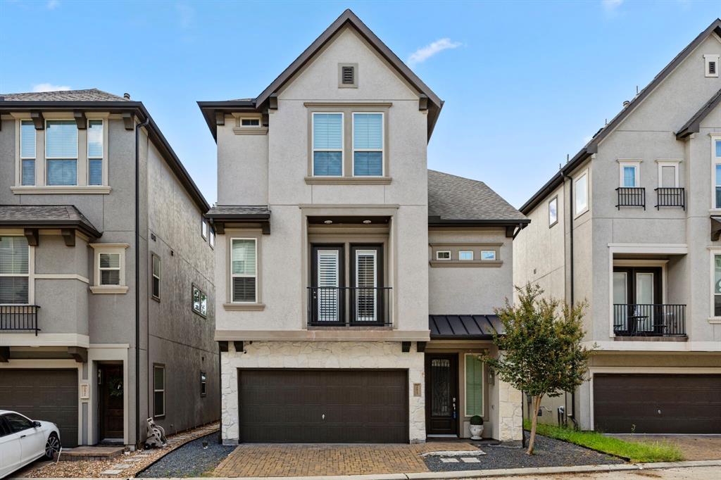 a front view of a house with garage