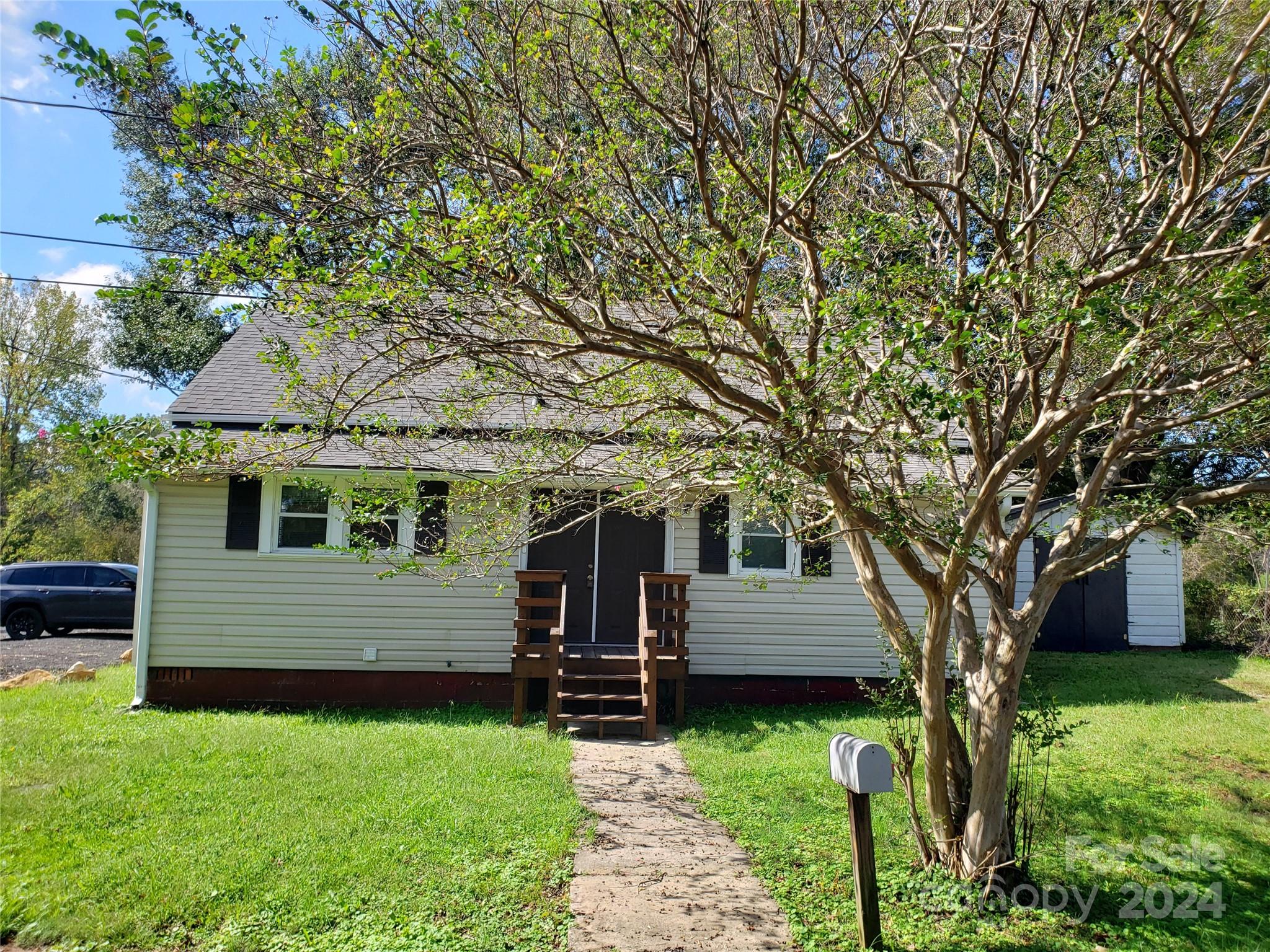 a front view of a house with a garden