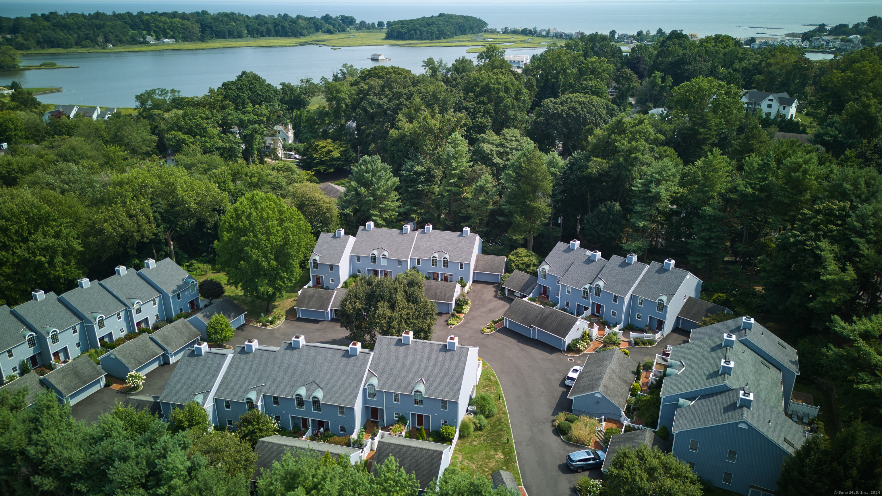 an aerial view of a house with outdoor space and lake view